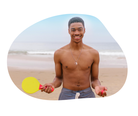A person on a beach with ping pong equipment